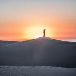 man standing on mountain peak